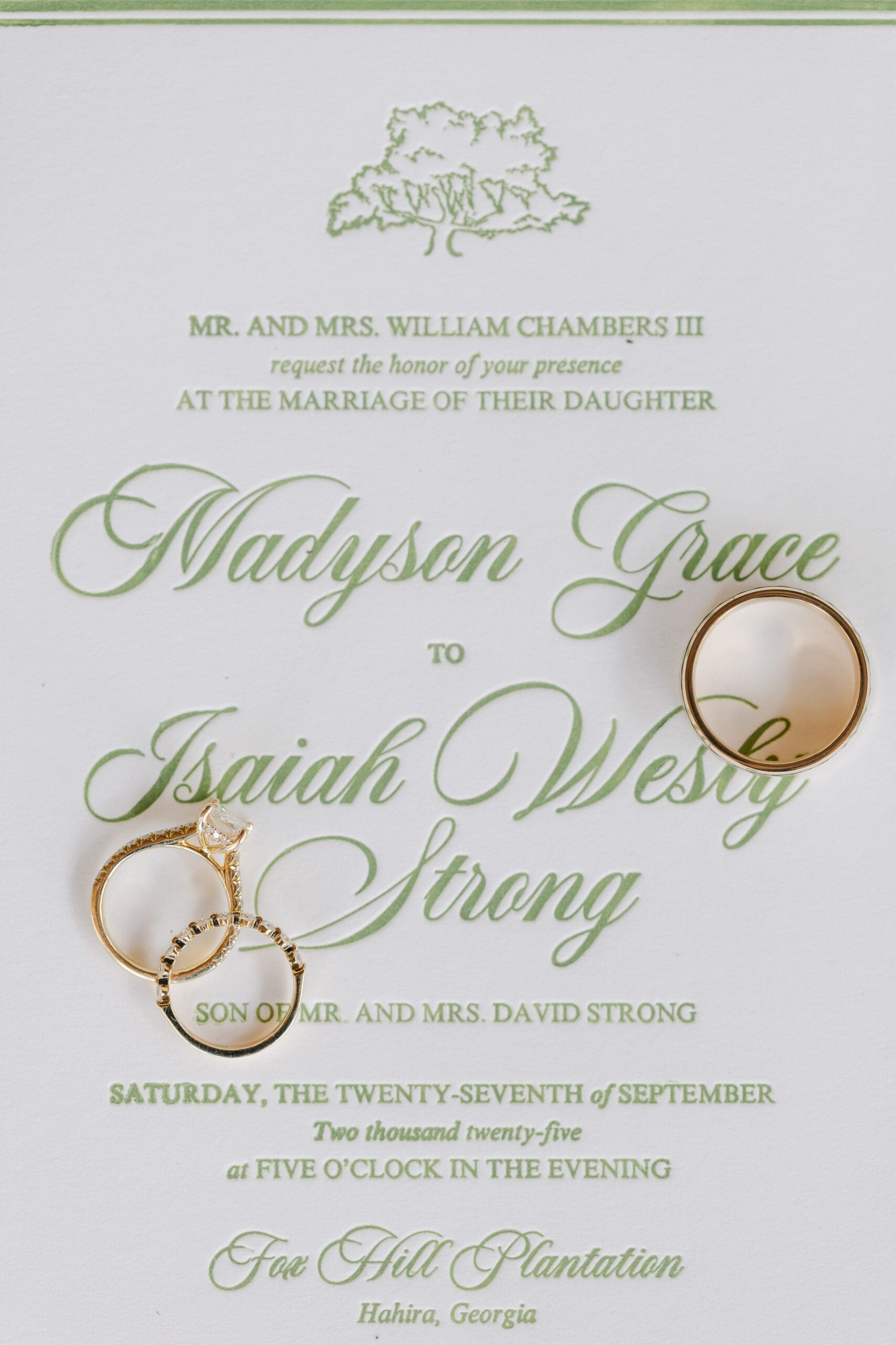 Wedding photographer's hand letter-pressed invitation suite with the rings laying on the suite